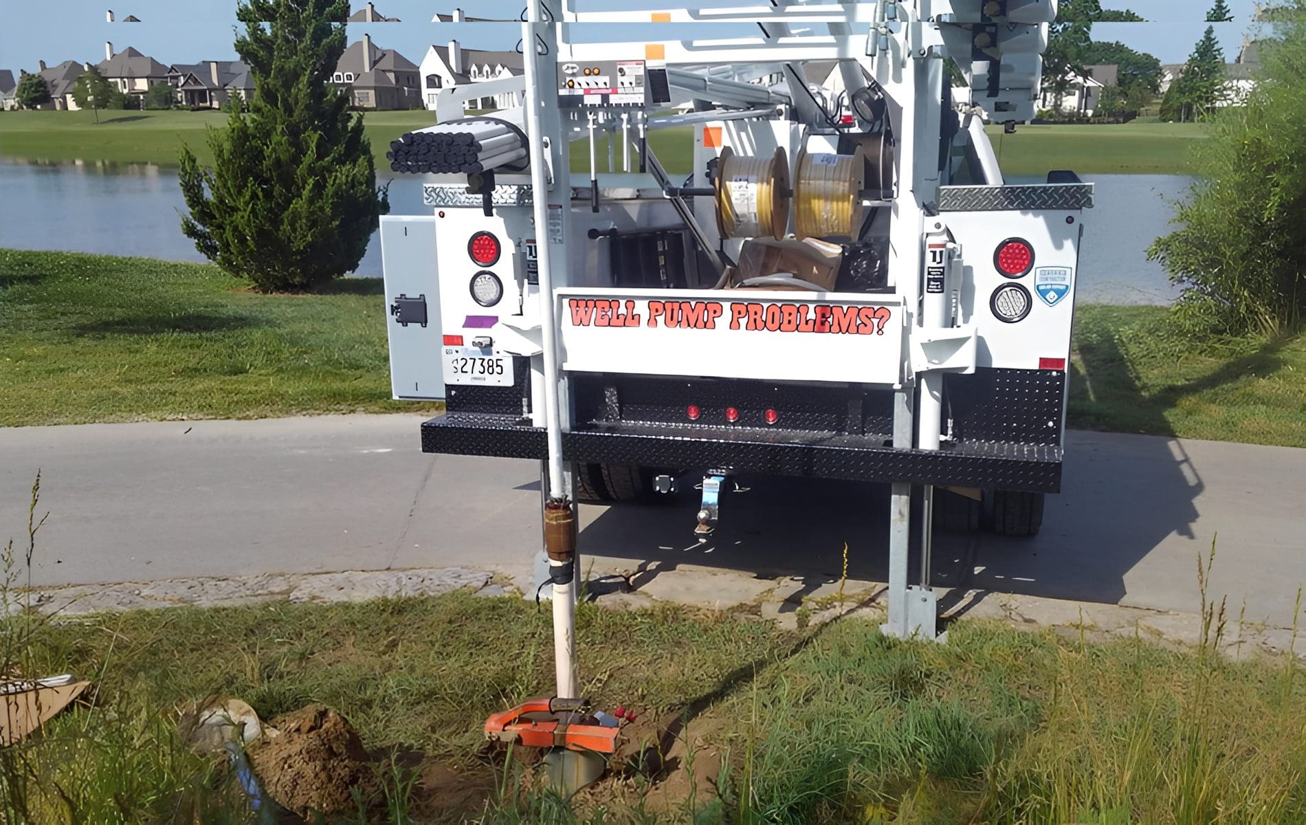 Well pump maintenance truck by a pond