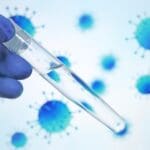 Gloved,Doctor's,Hand,Holds,Test,Tube,With,Transparent,Liquid,On