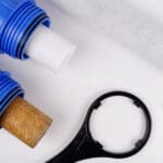 Water,Filter.,Carbon,Cartridges,And,Hand,Tools,Wrenches,On,White