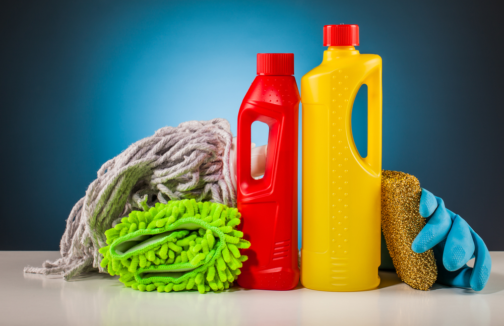 Colorful,Cleaning,Equipment,On,Table,And,Blue,Background