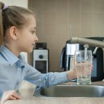 Little,Girl,Open,A,Water,Tap,With,Her,Hand,Holding