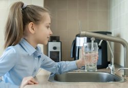 Little,Girl,Open,A,Water,Tap,With,Her,Hand,Holding
