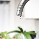 Bathroom,Faucet,Dripping,Water,With,Defocused,Background.,Close,Up,Of