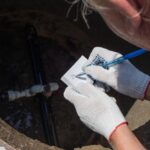 A,Man,Records,The,Readings,Of,The,Water,Meter,,Leaning