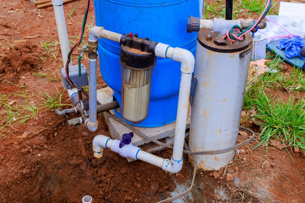 Plumber,Connects,Water,To,Well,Pump,With,An,Underground,Pipeline