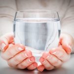 A,Glass,Of,Clean,Mineral,Water,In,Woman's,Hands.,Concept